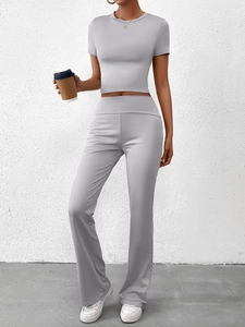Détail du haut court gris clair et du pantalon de sport évasé à taille haute