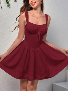 Close-up of wine red sleeveless dress showing drawstring detail and pleated hem stitching