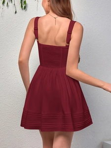 Detail view of burgundy summer dress featuring a smocked back and adjustable straps