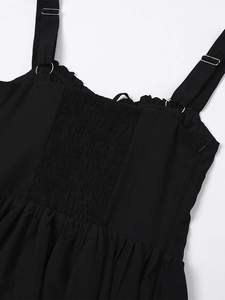 Detail of adjustable straps and elastic smocking back on a black summer mini dress