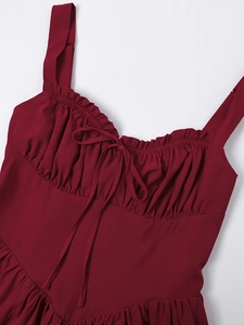 Detail of burgundy summer dress showing ruffled neckline and drawstring bow design