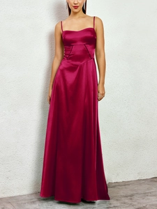 Detail of elegant magenta matte satin long dress with delicate spaghetti straps