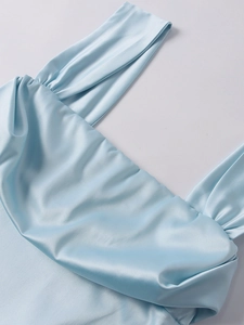 Détail d'une robe en satin bleu clair avec décolleté carré plissé élégant et larges bretelles