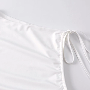 Detailed macro view of white knit fabric texture with adjustable side drawstring detail