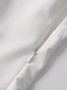 Detailed close-up of a white summer dress featuring a high-quality invisible back zipper