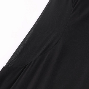 Detail of mesh patchwork and modal fabric on black dress shoulder and sleeve
