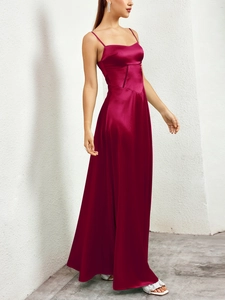 Detail of burgundy satin maxi dress featuring lace-up waist and elegant corset bodice