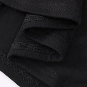 Detailed close-up showing high-quality double stitching on the hem of a black modal dress