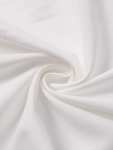 Macro detail of pure white woven fabric with soft pleats and fine matte texture