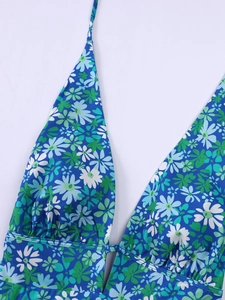 Detail of blue daisy floral halter dress with pleated texture and stretch fabric