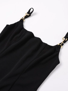 Detail view of square neck black dress featuring luxury gold horsebit metal buckle detail