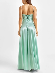 Detail of the mint green satin dress featuring a corset lace-up back and open back design
