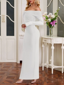 Detail of the elegant white off-shoulder maxi dress featuring gathered pleats and ruffles