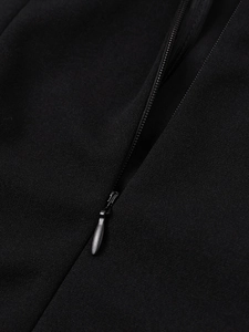Detailed macro view of the invisible zipper and high-quality textured fabric on black dress