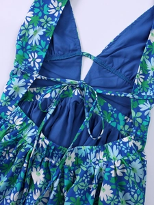 Detail of blue floral halter dress showing back lace-up straps and beach style pattern