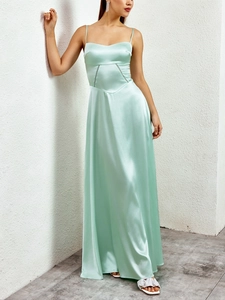 Detail of mint green satin maxi dress showing waist stitching and V-cut seam design
