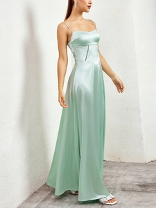 Close-up of mint green satin dress showing luxury matte fabric and waist hollow detail