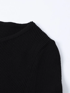 Detail of premium black rib-knit fabric texture and round neckline of a slim-fit dress