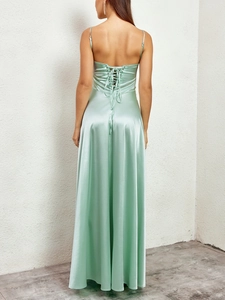 Detailed back view of mint green satin maxi dress with crisscross lace-up design