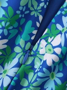 Detail view of the royal blue floral dress featuring a matching invisible zipper closure