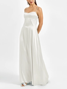 Detailed view of white satin dress featuring intricate triangular cutout at the waistline