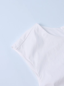 Close-up of the white tencel fabric texture and shoulder stitching detail on a sleeveless dress