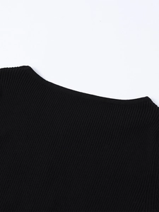 Detailed close-up of the ribbed knit neckline on a black slim-fit winter dress