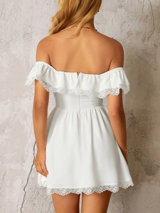 Close-up of the elegant lace trim and back view design on the white off-shoulder mini dress