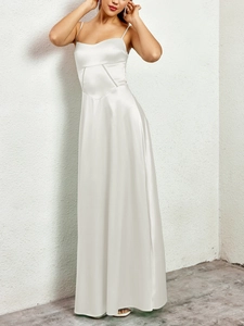 Detail of the elegant white matte satin long dress showing the fine stitching and fabric texture