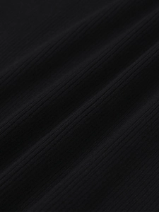 Detailed macro view of black ribbed knit fabric showing vertical texture and stretch