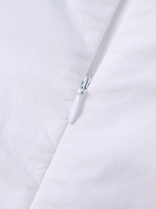 Detail of the high-quality invisible zipper closure on the white tencel textured fabric