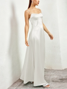 Close-up of pearl white satin slip dress texture and waist hollow out detail