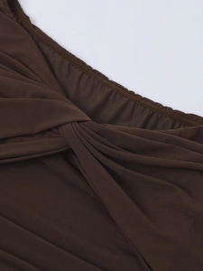 Detail view of dark brown mesh fabric showing elegant twisted pleats and ruched texture