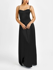 Detail showing high-waisted triangular stitching on a black matte satin dress