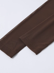 Close-up of deep brown mesh fabric texture and precise stitching on dress sleeves