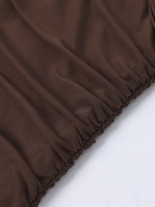 Close-up of ruched mesh fabric detail with elastic draping on a slim-fit dark brown dress