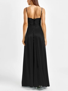 Detailed back view of a black satin maxi dress featuring an elegant lace-up open back design