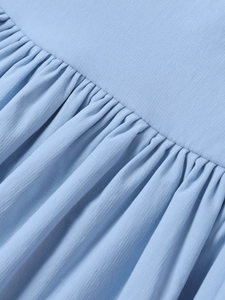 Macro shot of light blue tencel fabric showing fine pleated ruffles and textured detail