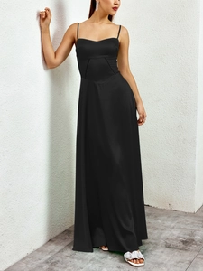 Detail of elegant black satin dress featuring a sweetheart neckline and waist cutout design