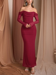Detail of burgundy off-shoulder gown featuring sheer mesh pleats and a slim fishtail hem