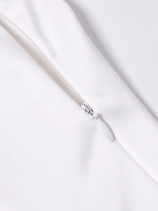 Detailed macro view of high-quality invisible zipper on a white satin mini dress