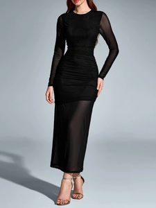 Detail of ruched black mesh long sleeve maxi dress with sheer hem and bodycon fit