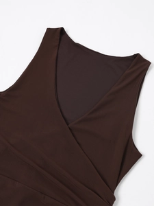Detail of deep V-neck wrap sleeveless mesh dress with textured pleated fabric