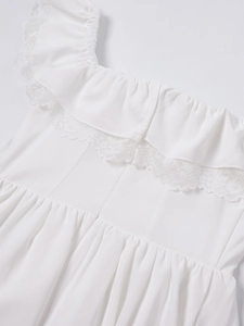 Detail view of white lace trim and ruffled square neckline on a summer mini dress