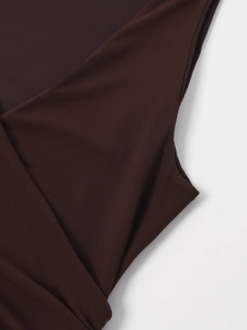Macro detail of the dark brown mesh fabric texture on the sleeveless V-neck dress