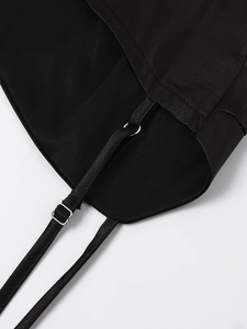Detail of adjustable thin shoulder straps with silver metal buckles on a black satin dress