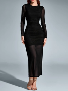 Detailed view of the ruched texture and sheer mesh sleeve on this black bodycon dress