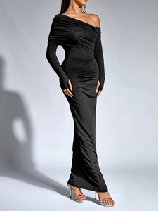 Detail of elegant black off-shoulder ruched dress with long sleeves and floor-length hem