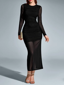 Close-up of ruched texture and sheer mesh sleeves on a black bodycon maxi dress