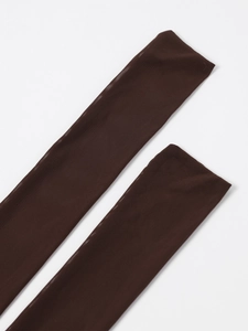 Detailed macro view of sheer brown mesh fabric showing fine breathable texture and netting
